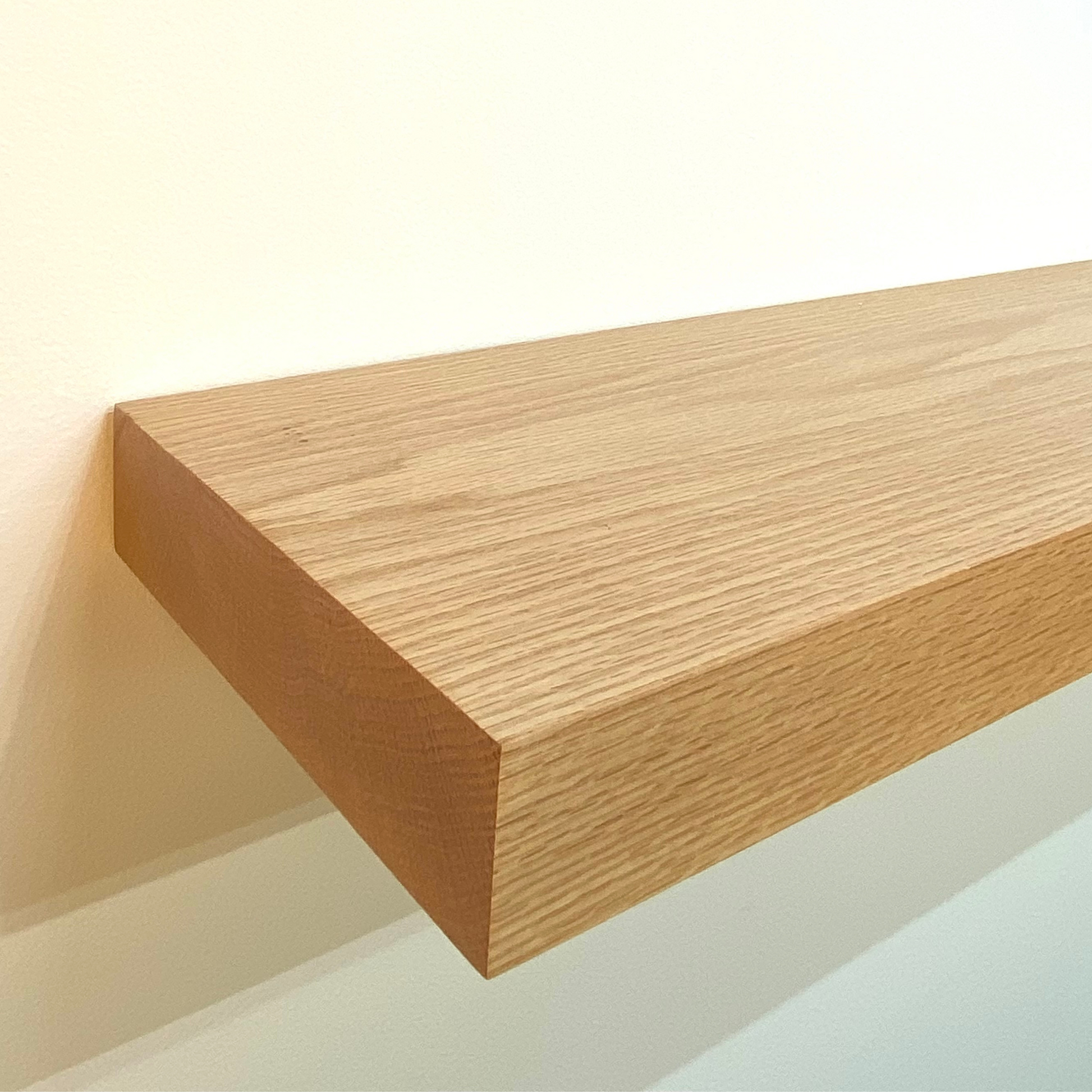 red oak floating shelf with hidden bracket on wall